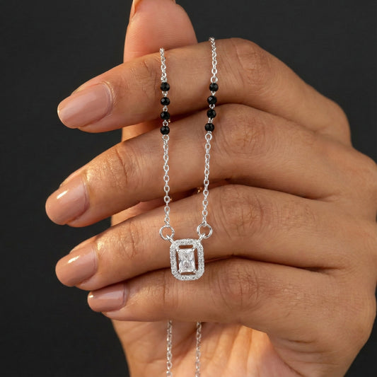 Modern silver mangalsutra featuring black beads and rectangular pendant