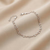 Two-layered silver bracelet on a beige fabric background