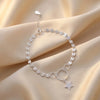 Silver bracelet with a star charm on a beige fabric background