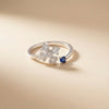Silver ring with diamond and sapphire on a beige background
