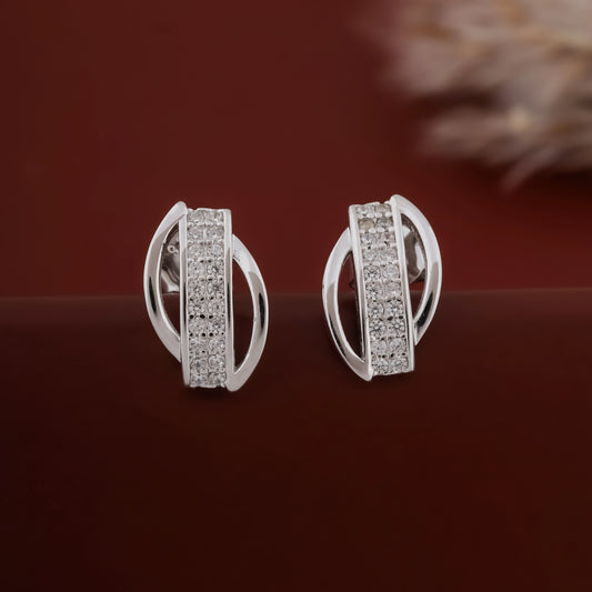 Silver earrings with gemstones on a dark red background