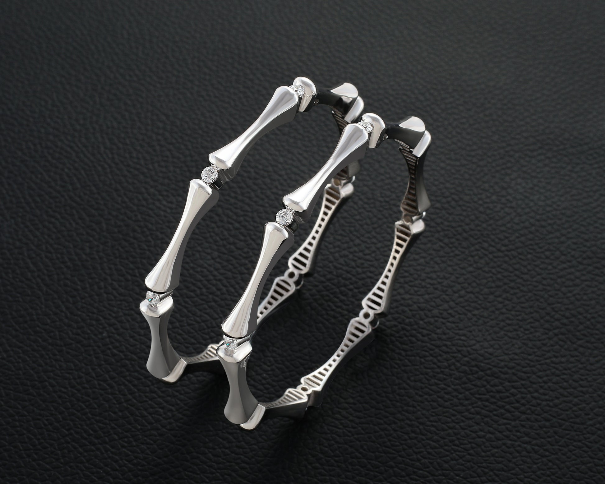 Silver bracelet with bone-like design on a dark textured background
