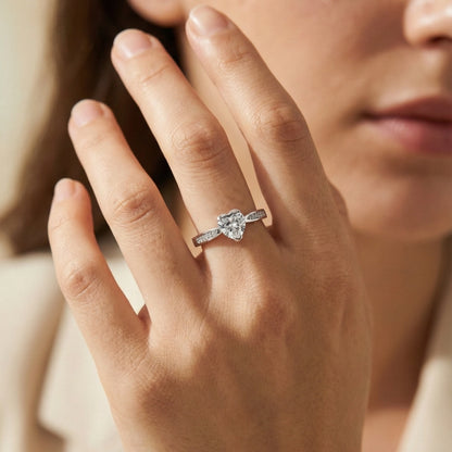 Close-up of a hand wearing a diamond ring with a blurred background