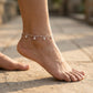 Anchored anklet on a foot with a blurred background