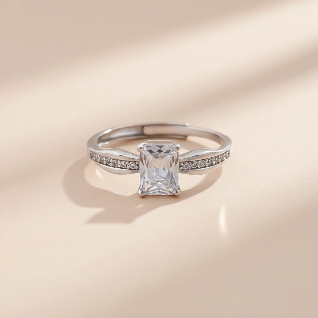 Silver ring with a diamond on a beige background