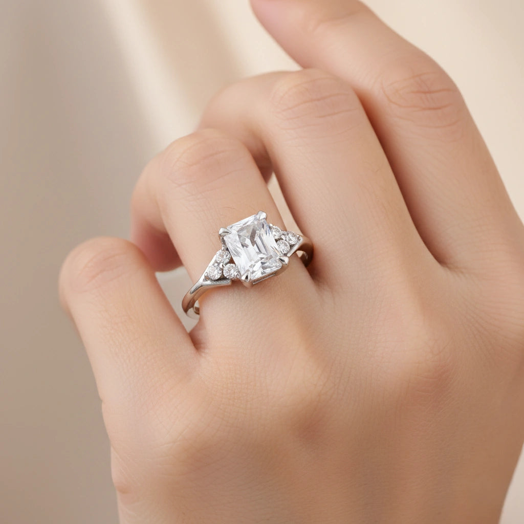 Diamond ring on a hand against a neutral background