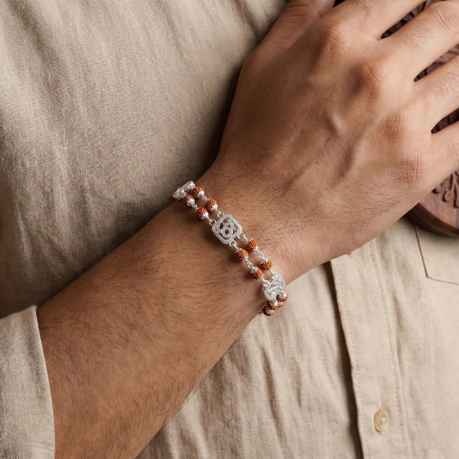 Close-up of a wrist wearing a bracelet with a neutral background