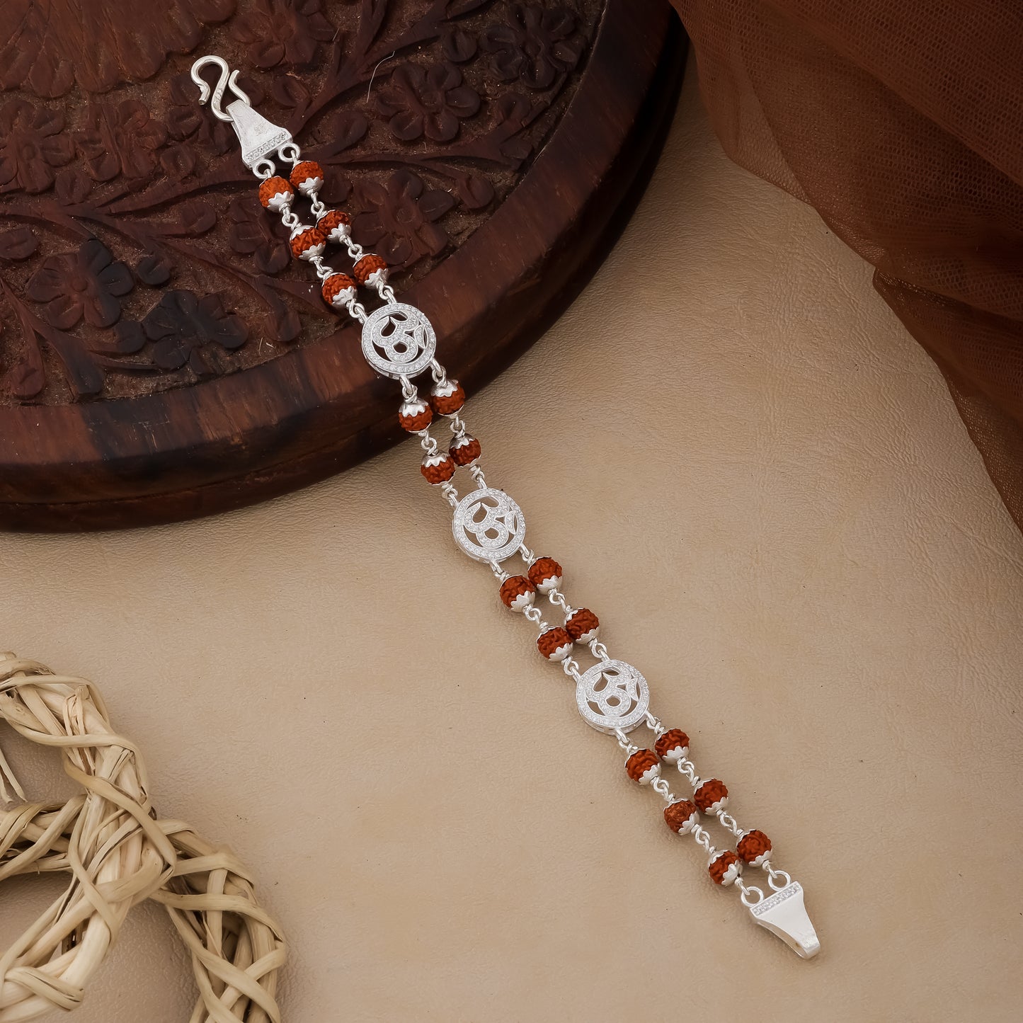 Silver bracelet with red beads on a wooden surface