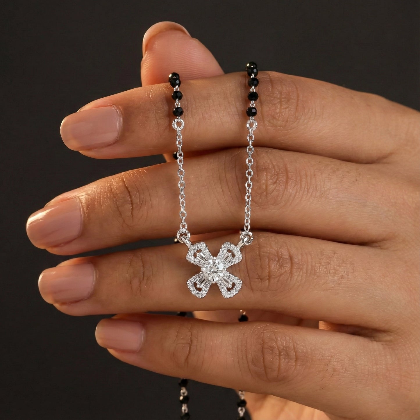 Silver mangalsutra with black beads and cross-shaped diamond pendant