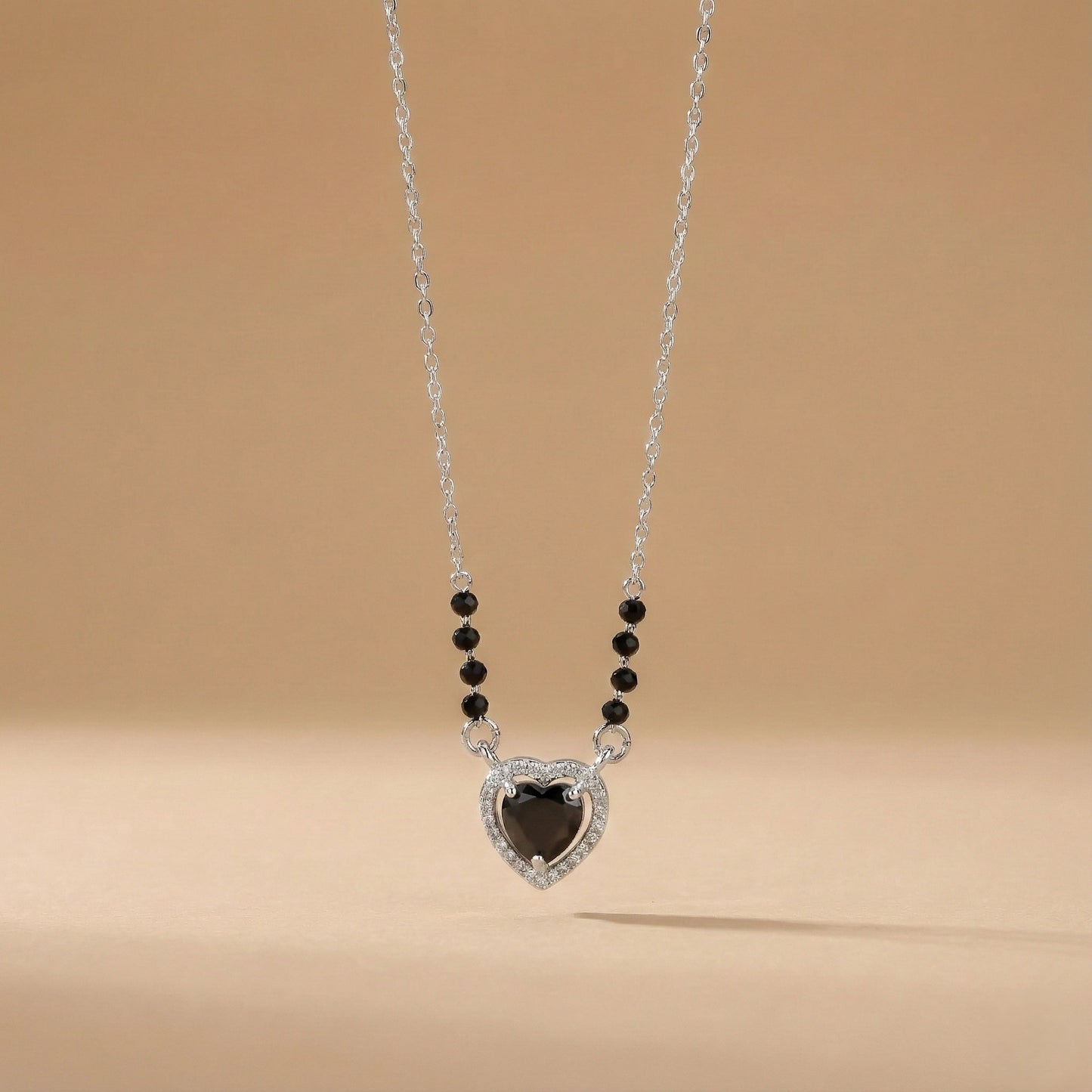 Contemporary mangalsutra with black beads and teardrop halo pendant