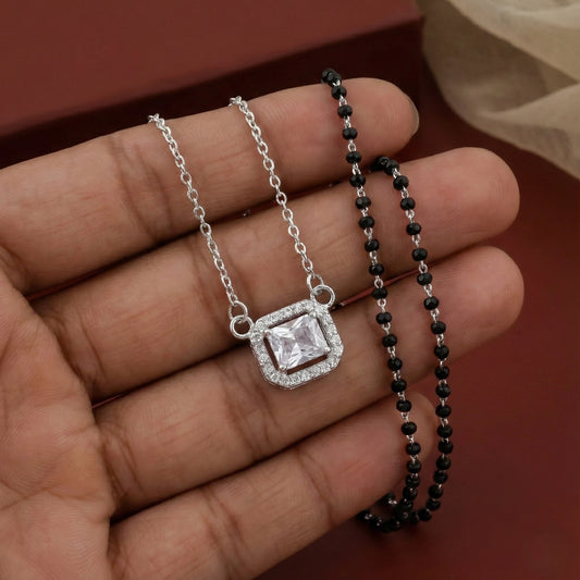 Modern silver mangalsutra featuring black beads and rectangular stone pendant