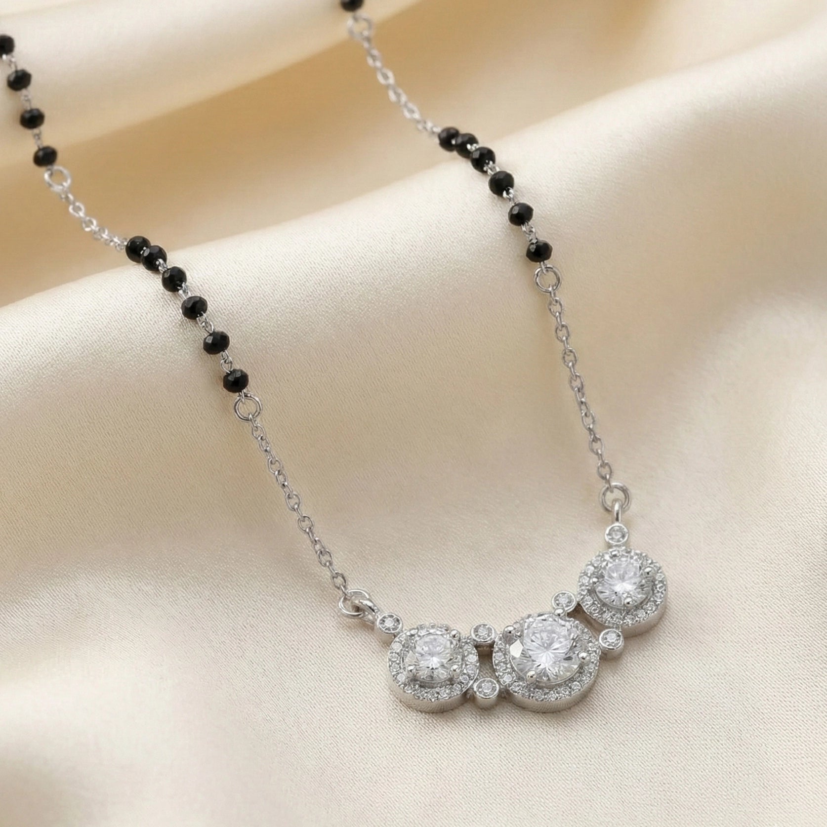 Silver mangalsutra with black beads and three round diamond halo pendants