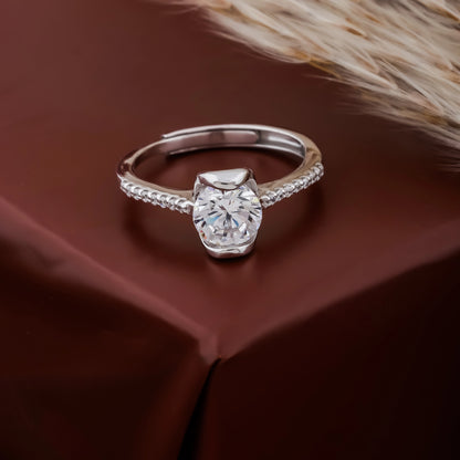 Silver ring with a large diamond on a brown fabric background