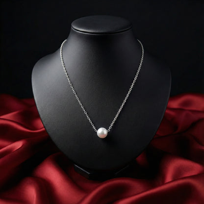 Pearl necklace on a black bust with red fabric background