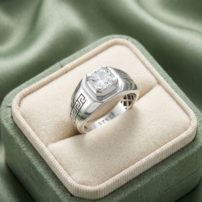 Silver ring with a diamond on a green cushioned box