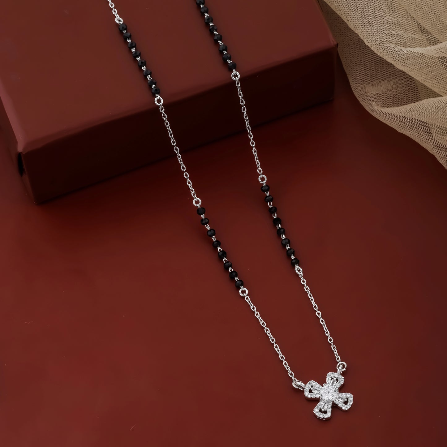 Contemporary mangalsutra with black beads and geometric cross pendant