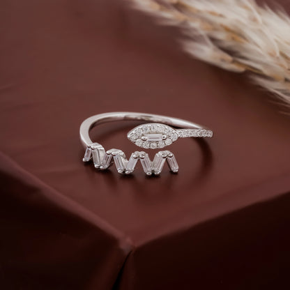 Silver ring with gemstones on a brown fabric background