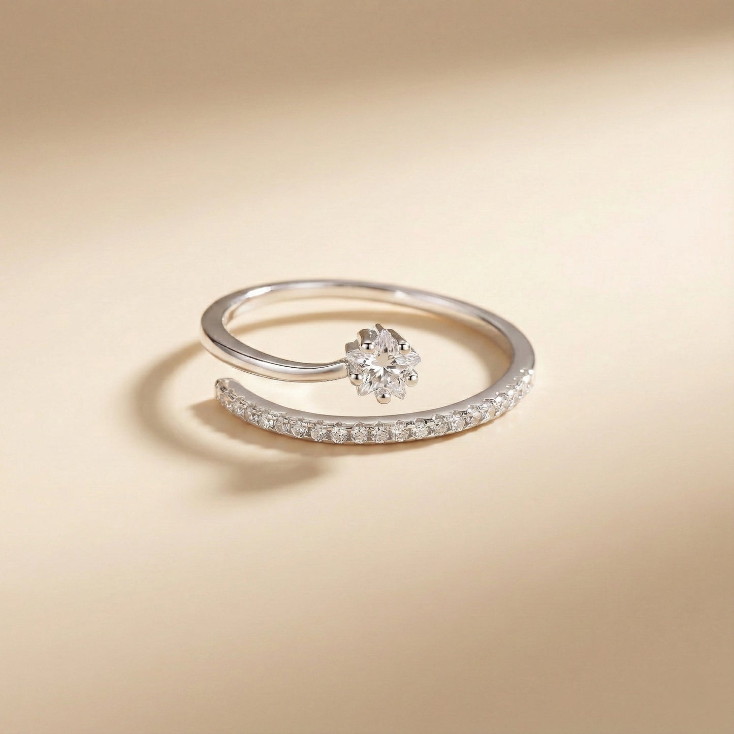 Silver ring with a floral design on a beige background