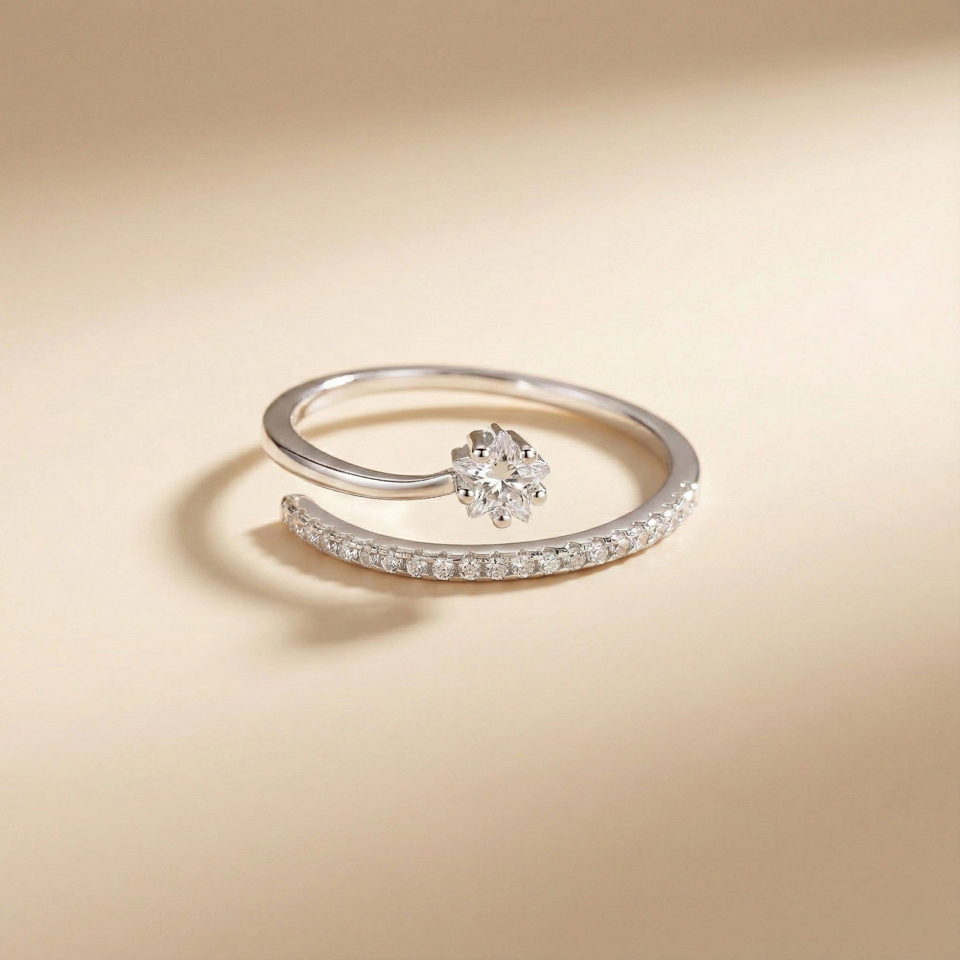 Silver ring with a floral design on a beige background