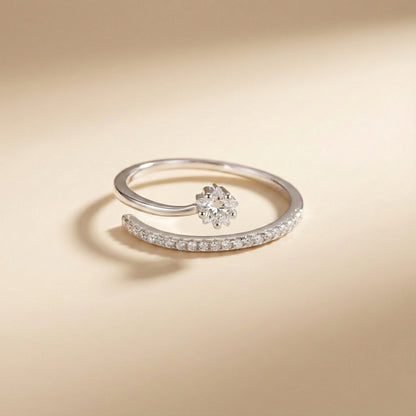 Silver ring with a floral design on a beige background