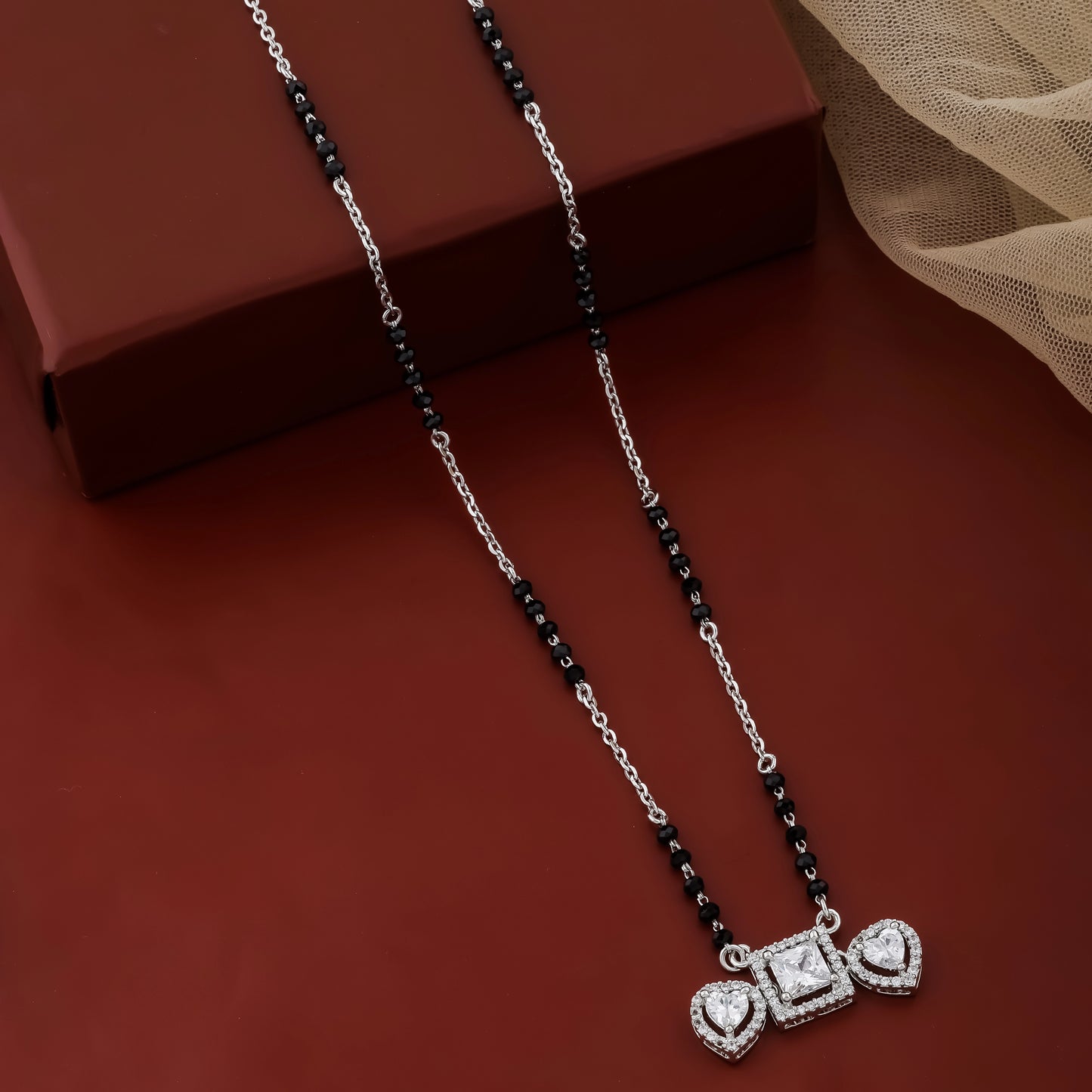 Necklace with a heart-shaped pendant on a brown surface