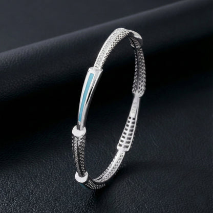 Silver bracelet with a blue accent on a dark background