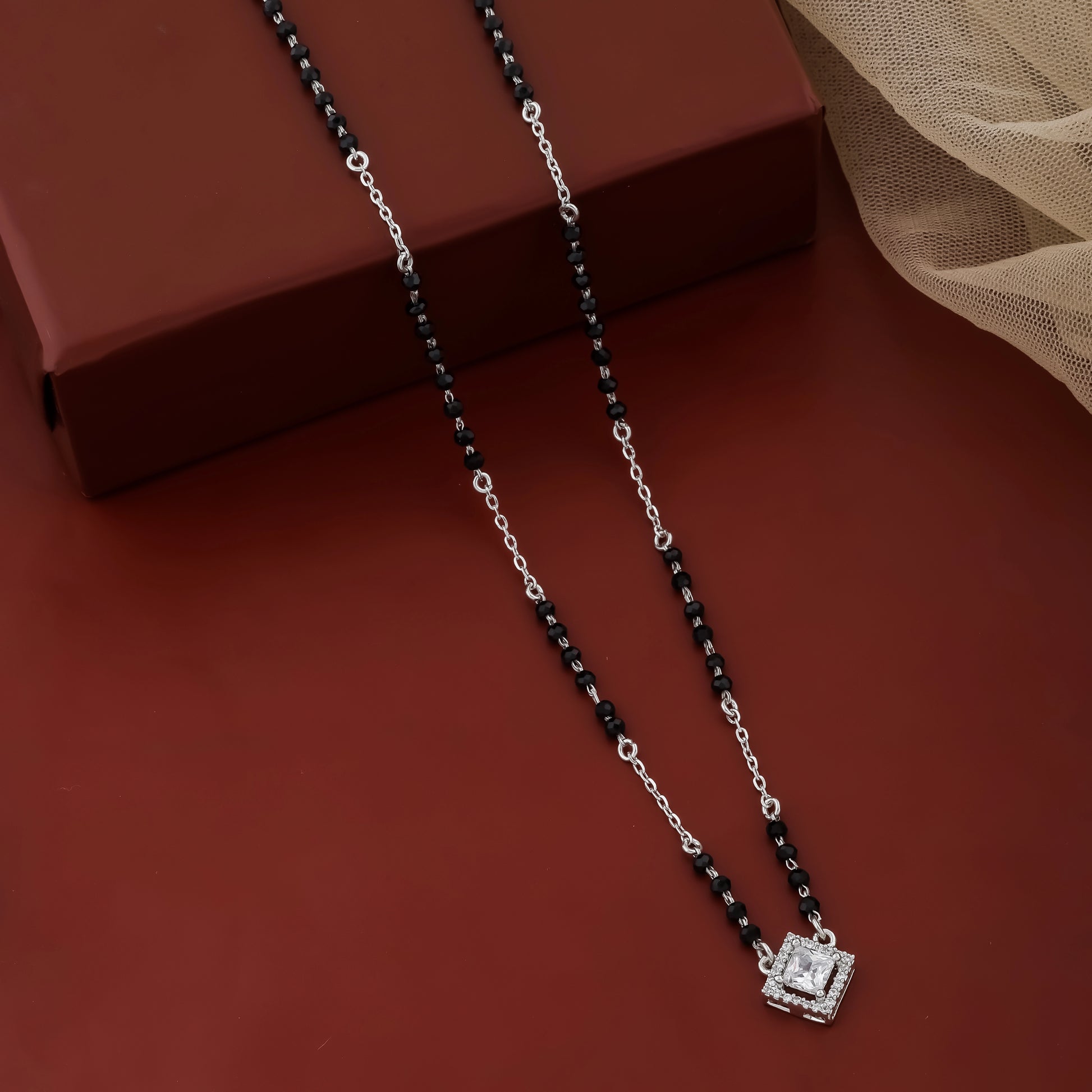 Modern silver mangalsutra featuring black beads and square pendant
