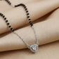 Modern silver mangalsutra featuring black beads and heart pendant
