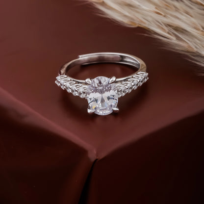 Silver ring with a large diamond on a brown fabric background