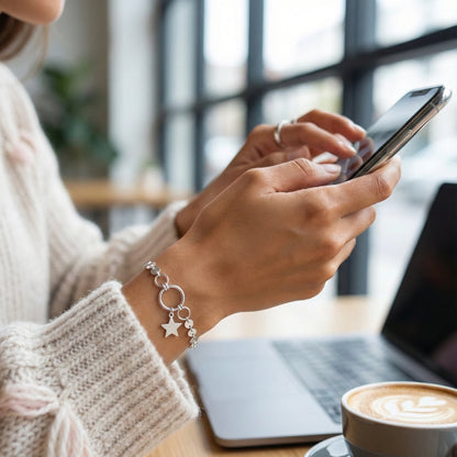 Person using a smartphone with a blurred background of a cafe setting