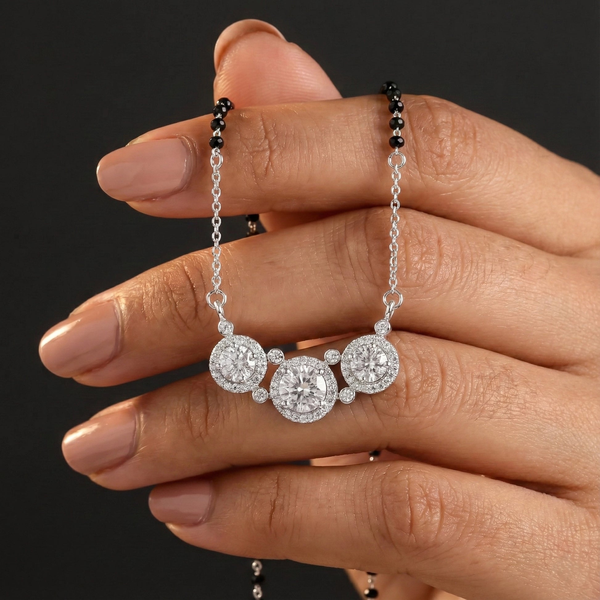 Modern silver mangalsutra featuring black beads and triple round pendants