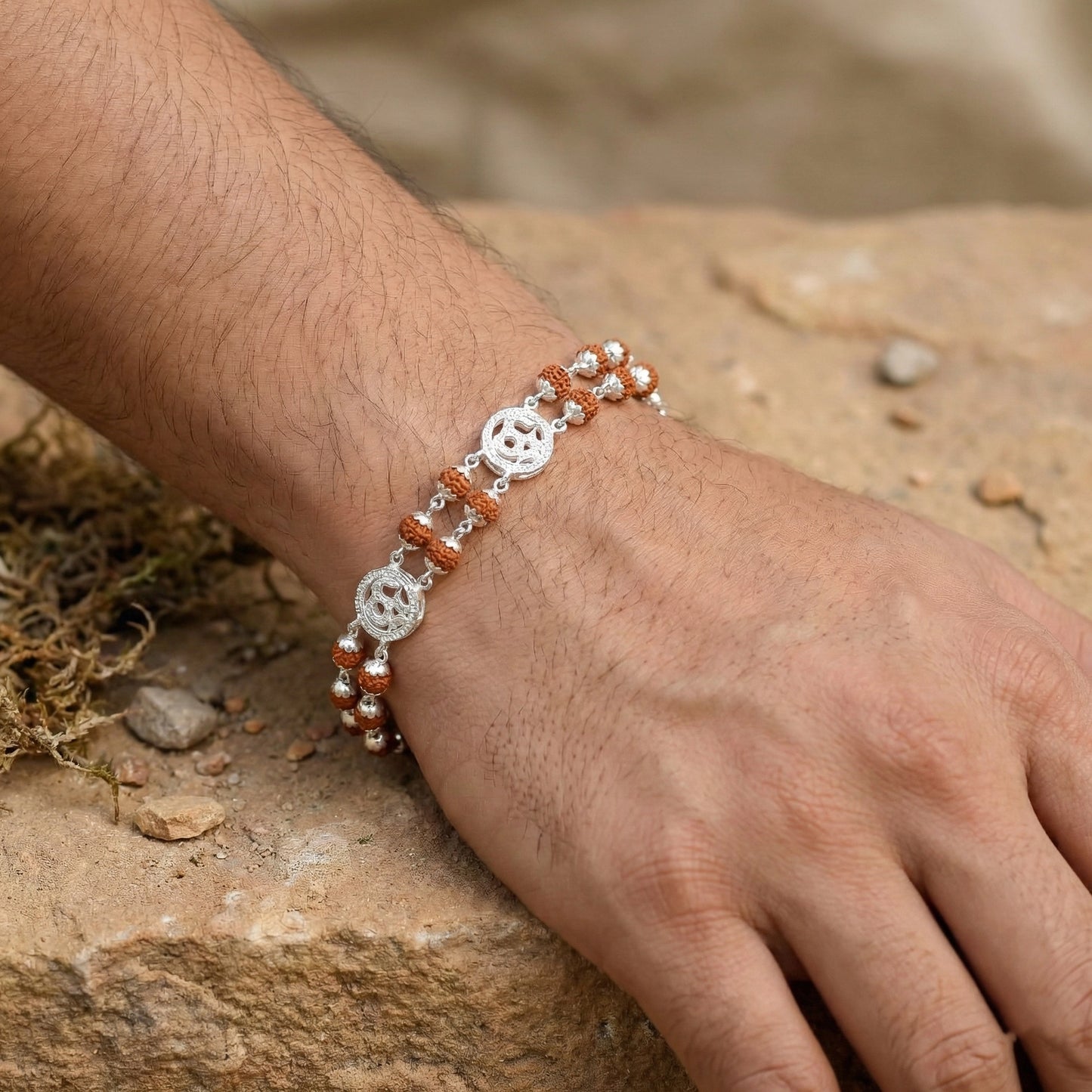 Close-up of a hand wearing a bracelet with a natural background