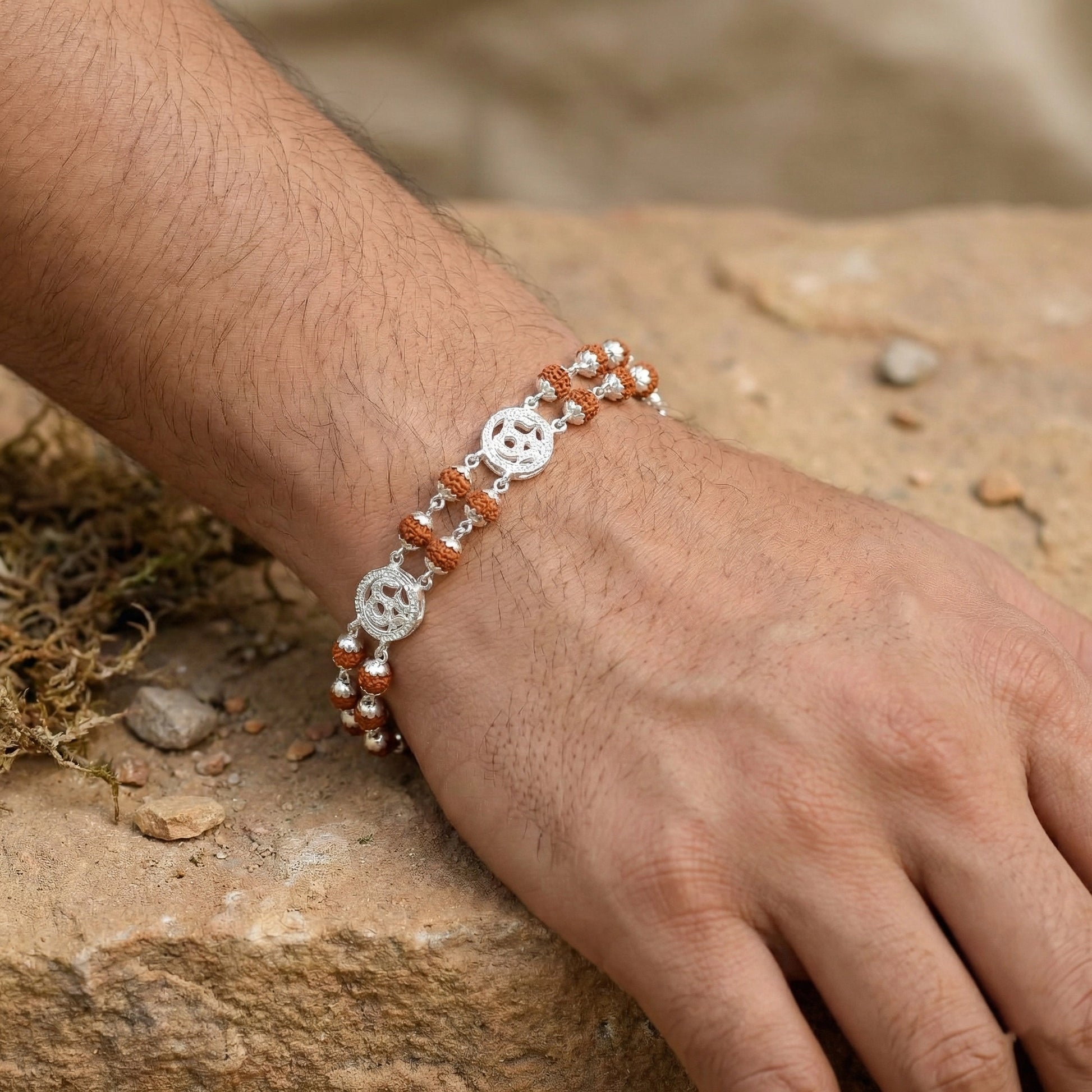 Close-up of a hand wearing a bracelet with a natural background
