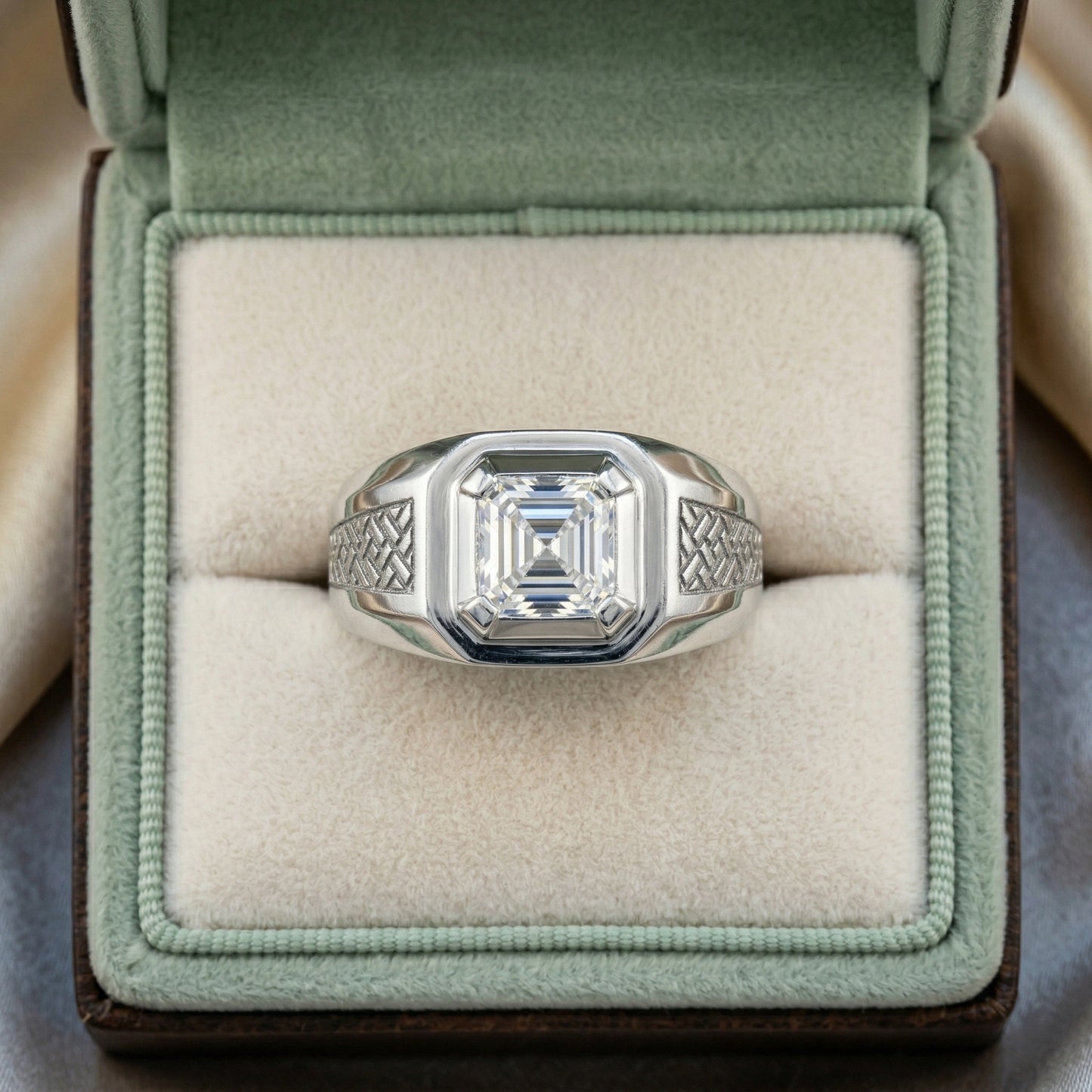 Silver ring with a large diamond in a green velvet box