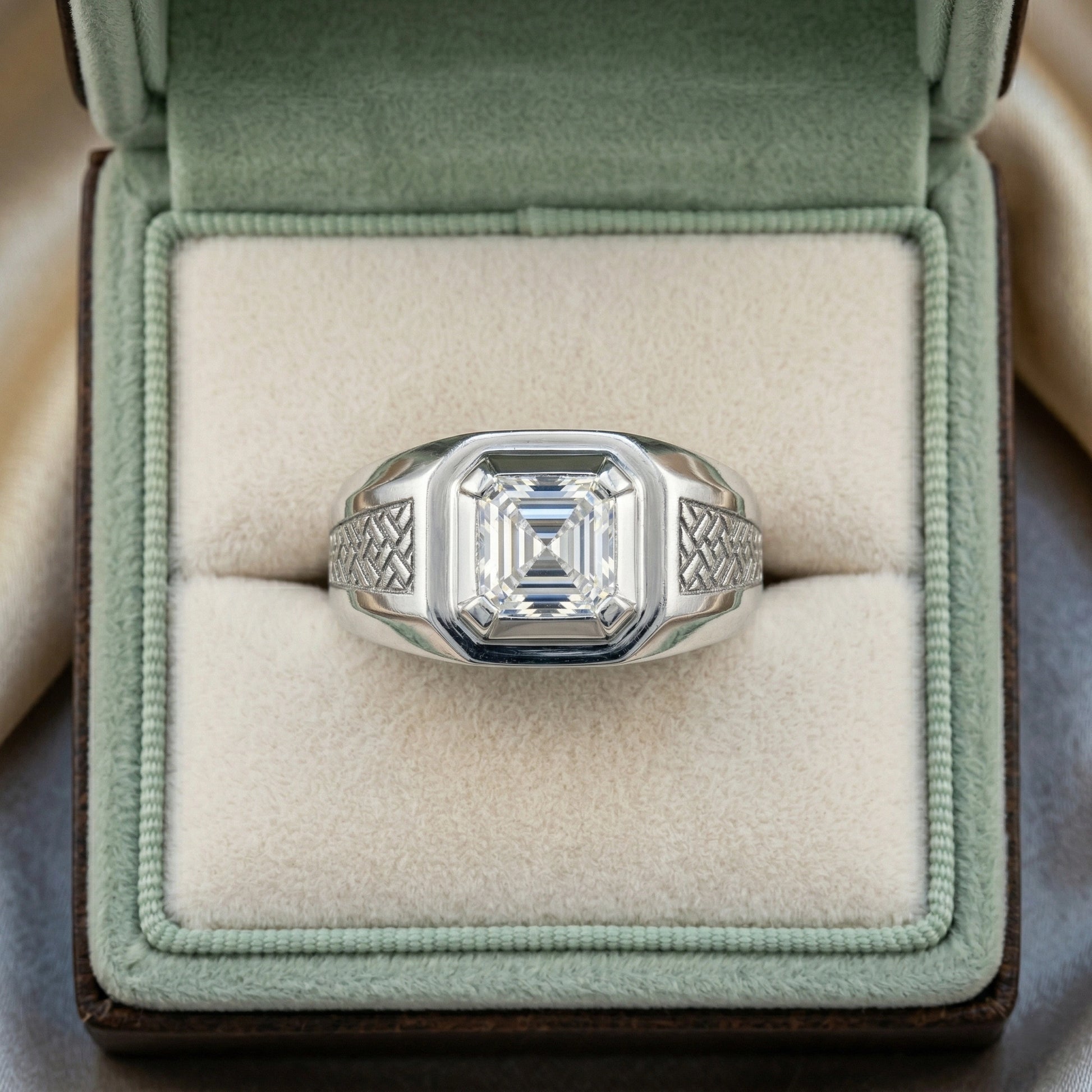 Silver ring with a large diamond in a green velvet box