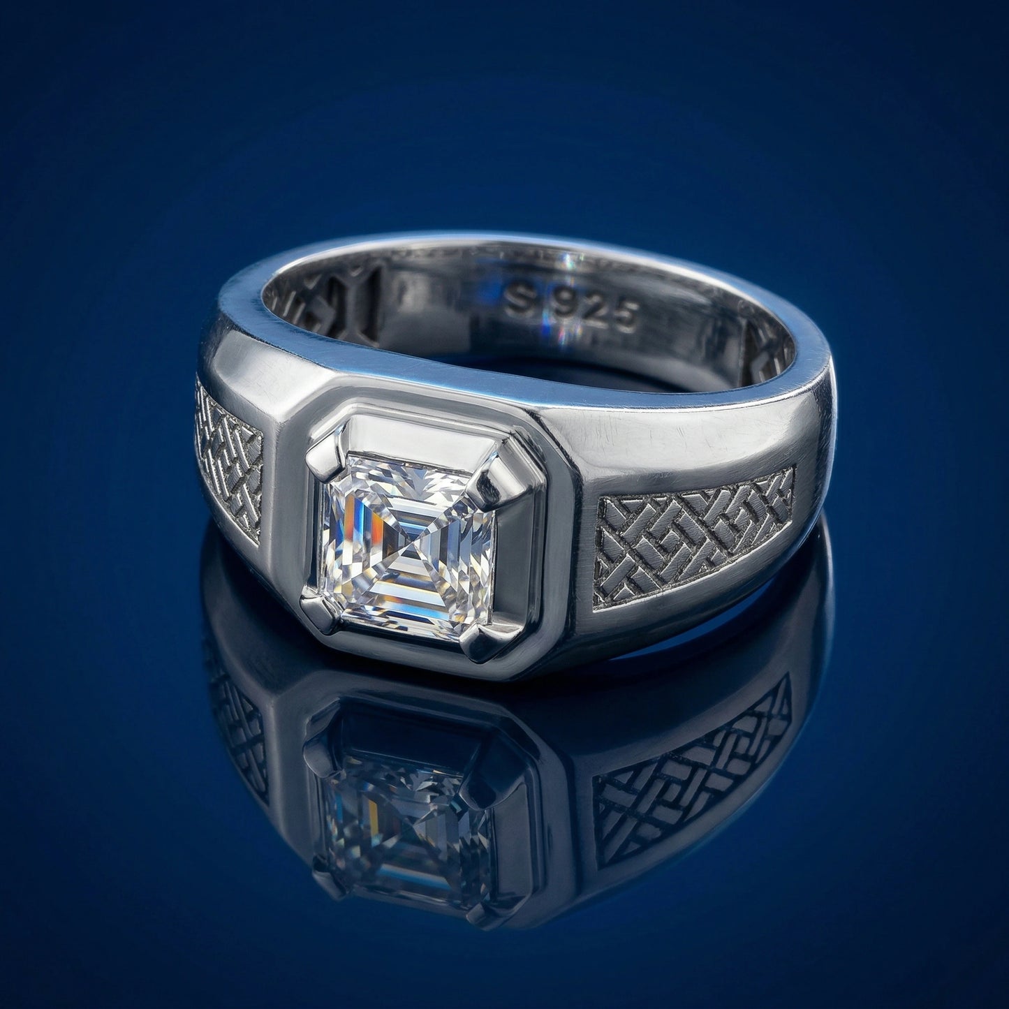 Silver ring with a diamond on a reflective blue surface