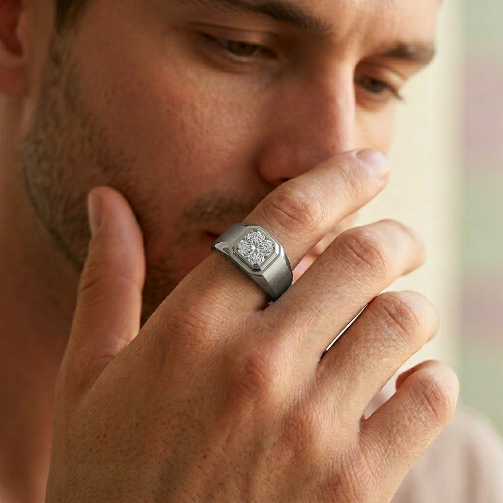 Man wearing a silver ring with a diamond on his finger, close-up shot.