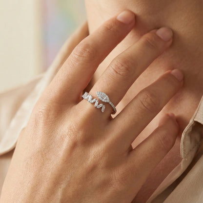 Close-up of a hand wearing two silver rings with a soft background