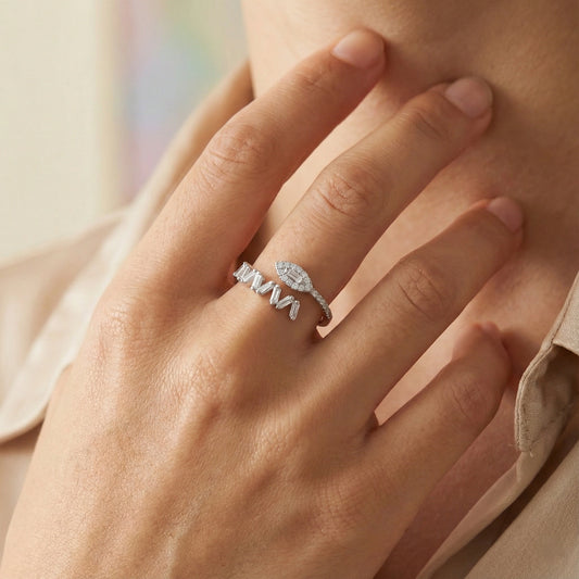 Close-up of a hand wearing two silver rings with a soft background
