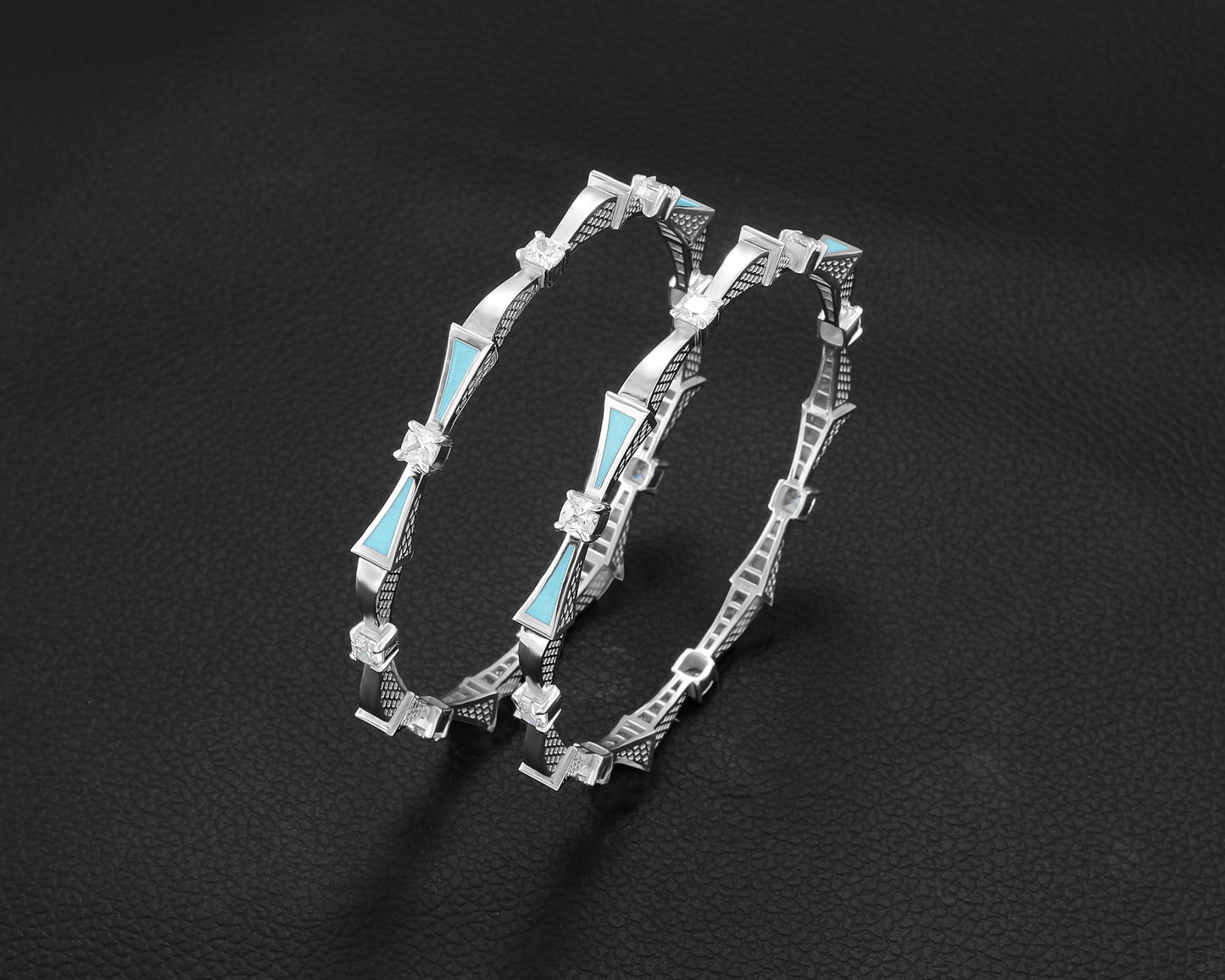 Silver bracelet with blue accents on a dark background