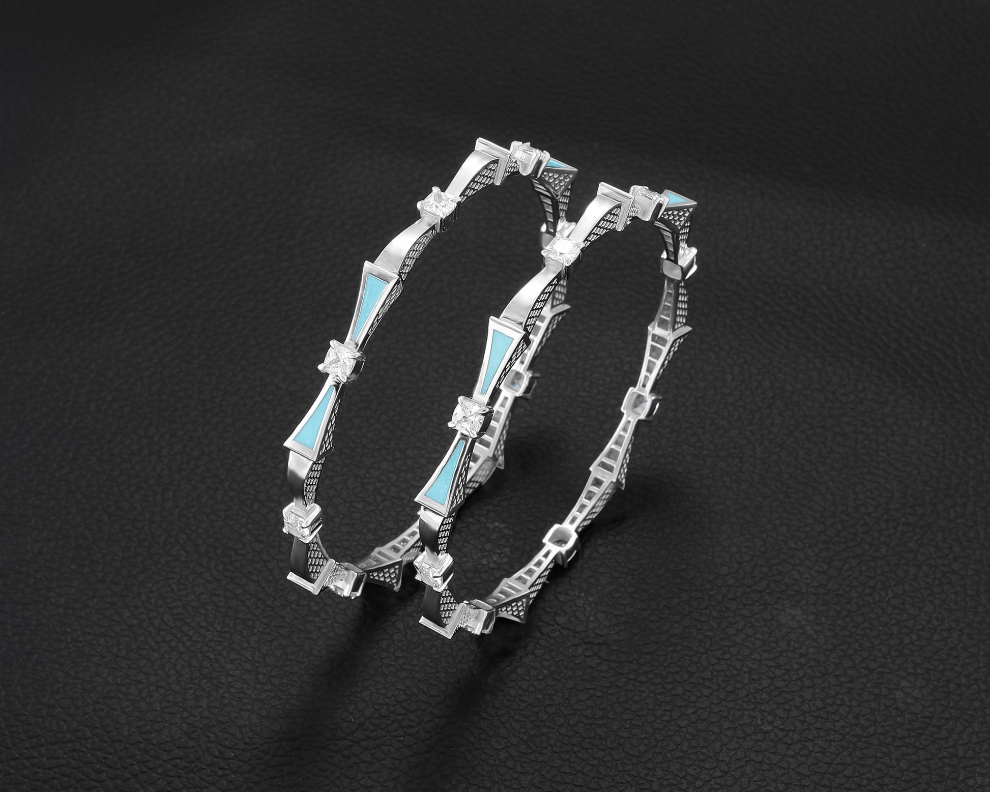 Silver bracelet with blue accents on a dark background