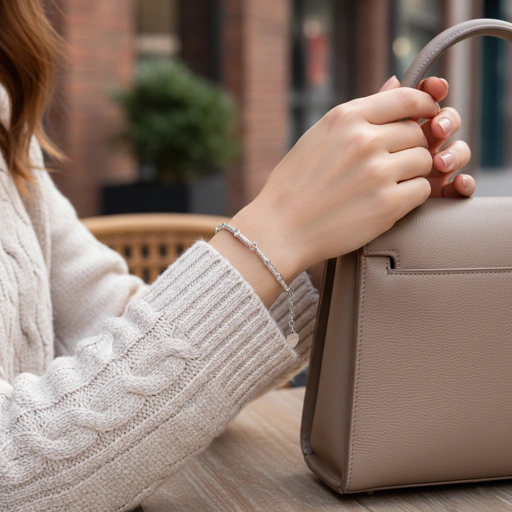 Person holding a beige handbag with a blurred background