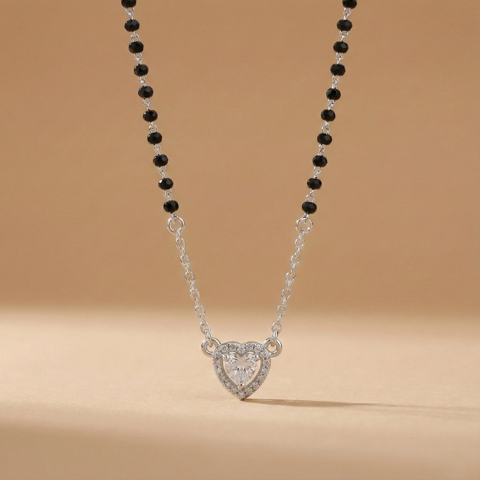 Modern silver mangalsutra featuring black beads and heart pendant