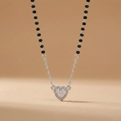 Modern silver mangalsutra featuring black beads and heart pendant