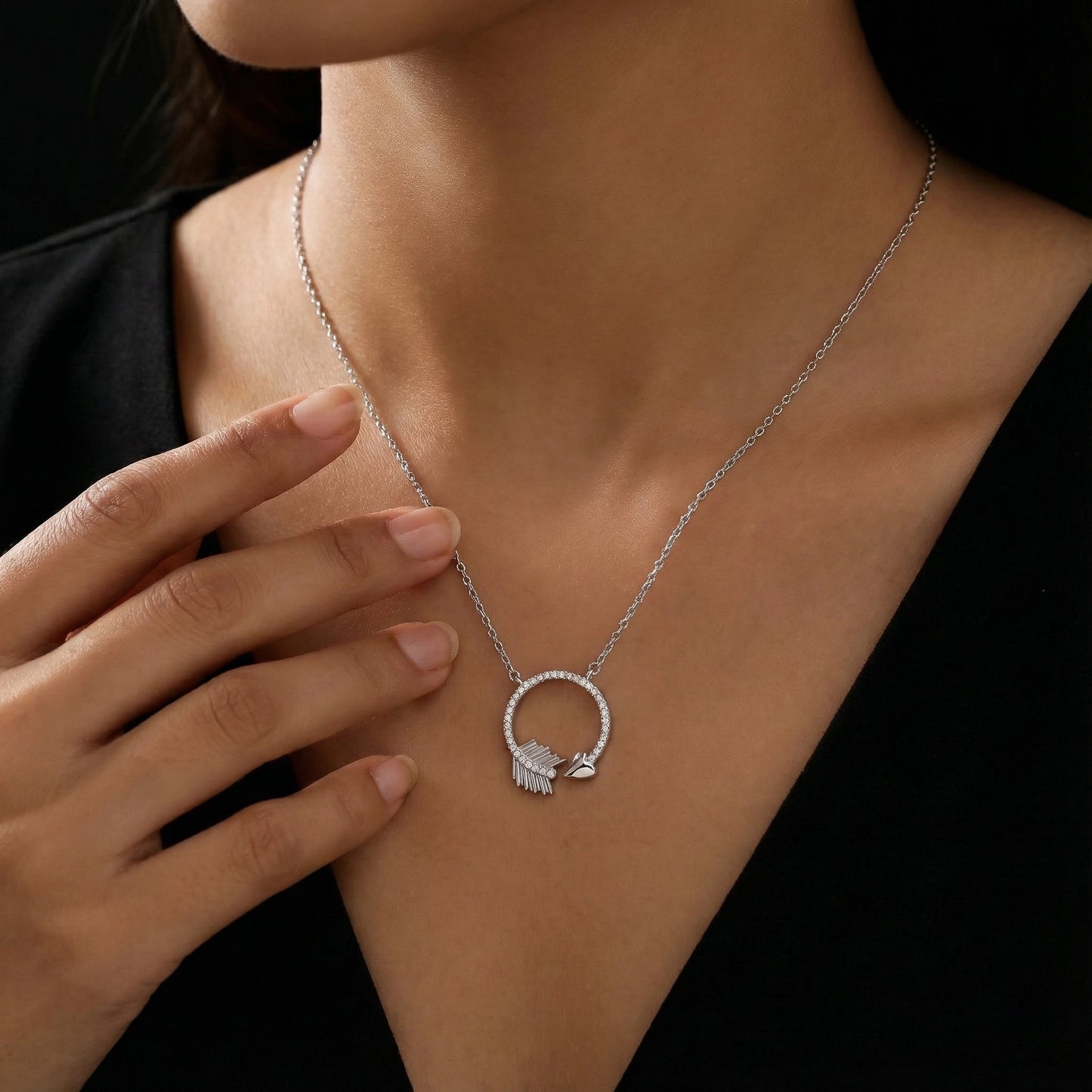 Necklace with a heart-shaped pendant worn by a person against a black background