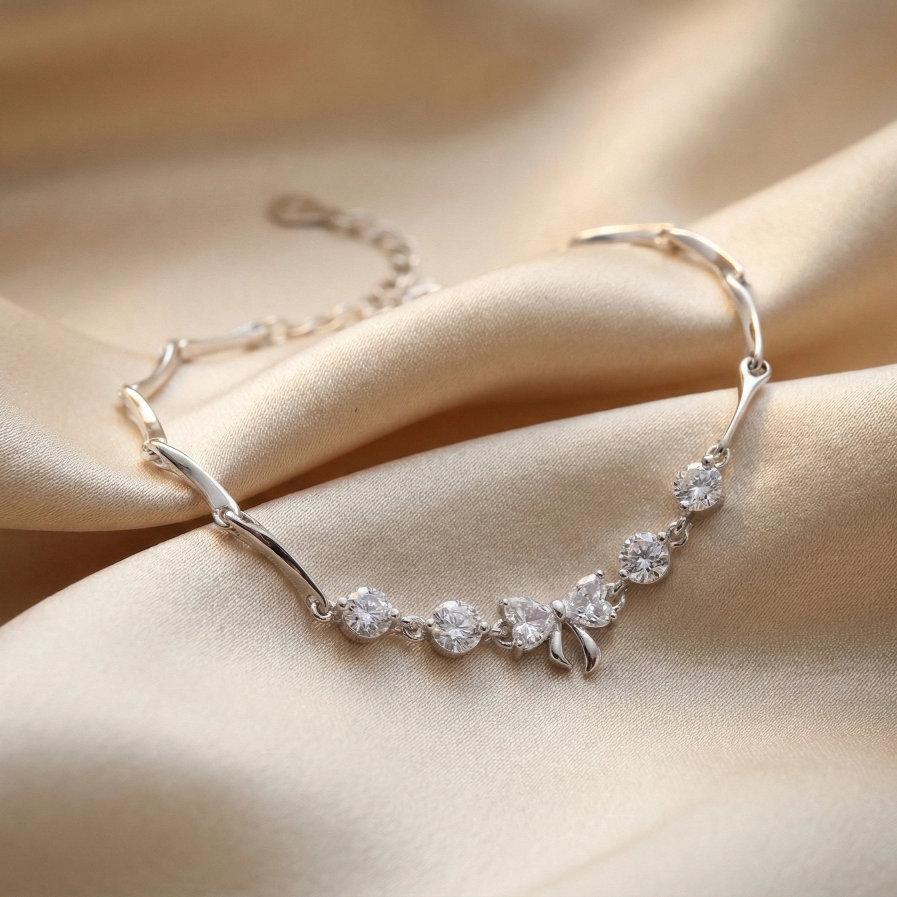Silver bracelet with clear stones on a beige fabric background