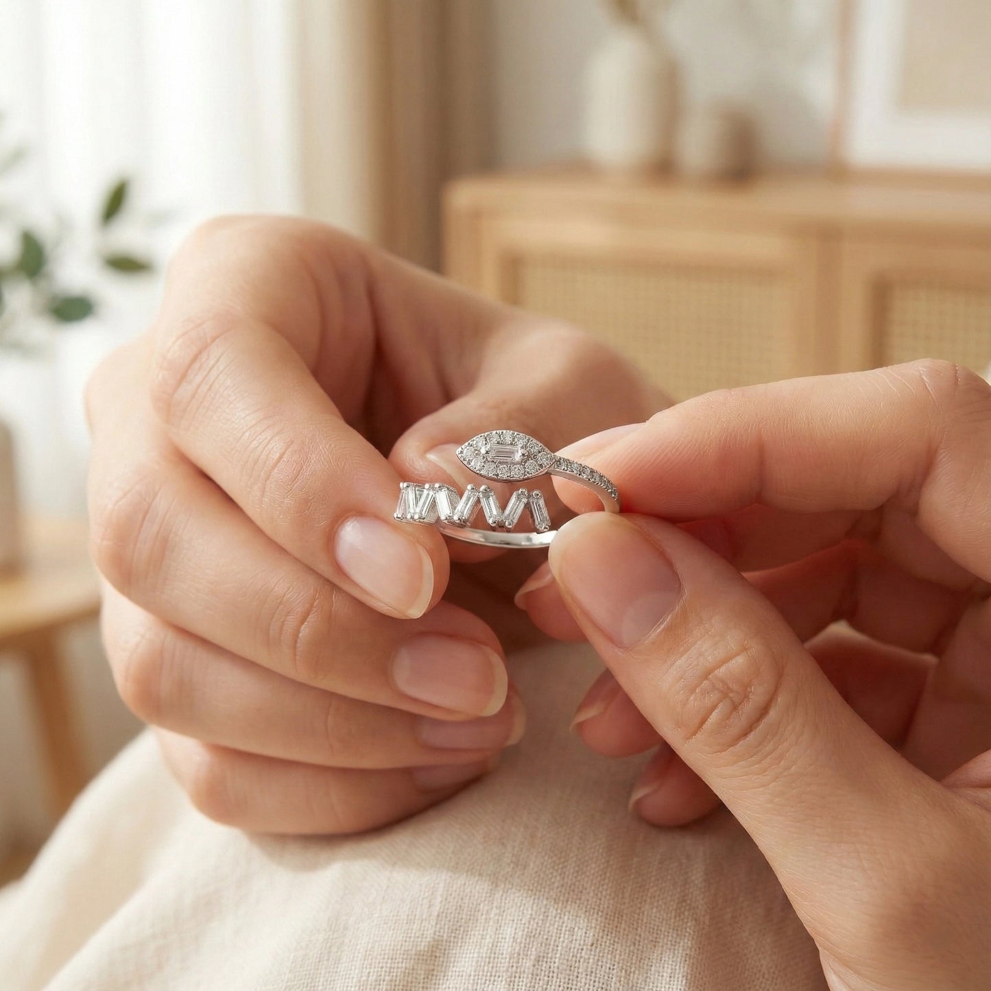 Close-up of hands holding a silver ring with a diamond