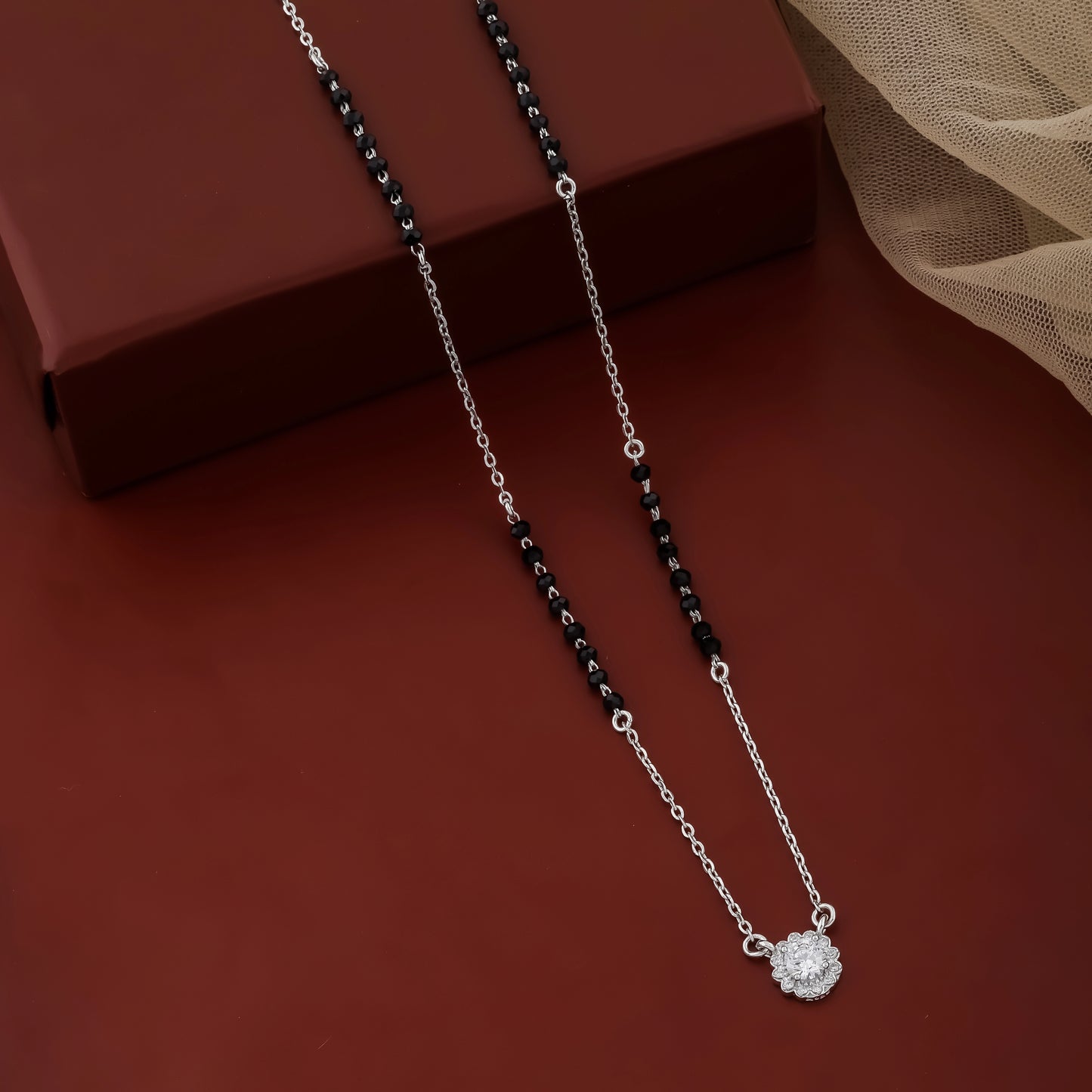 Contemporary mangalsutra with black beads and flower design pendant