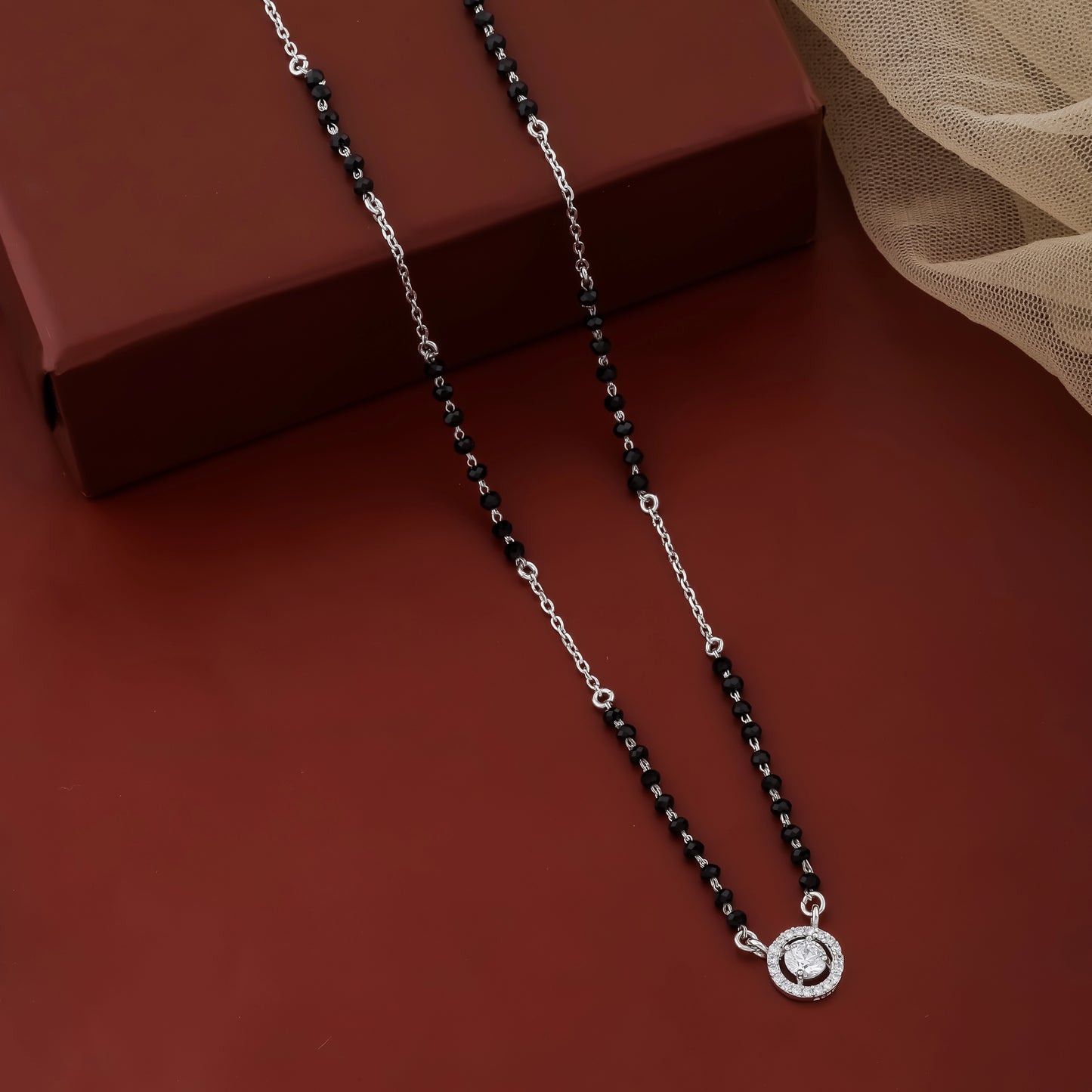 Contemporary mangalsutra with black beads and circular halo pendant