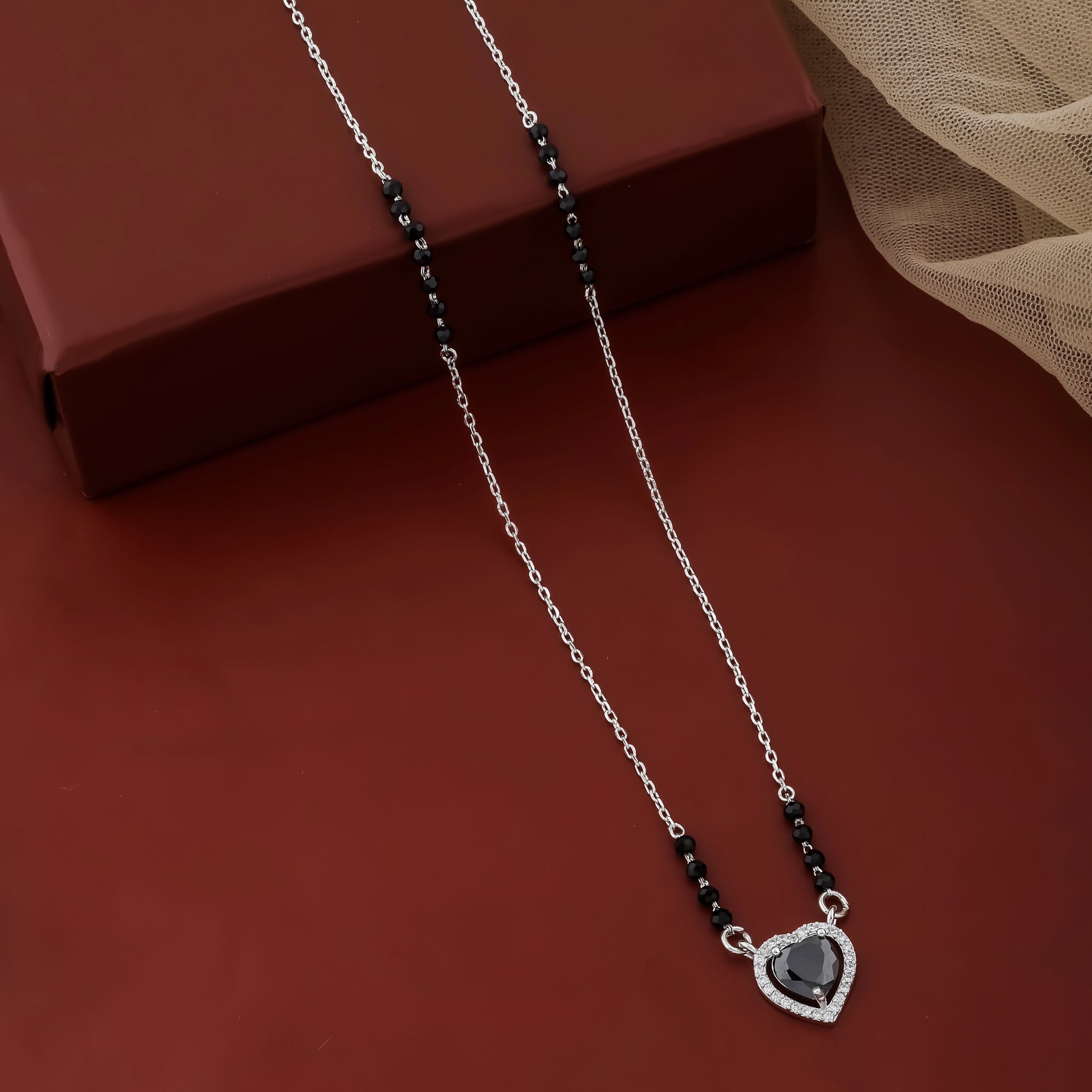 Elegant silver mangalsutra necklace with black teardrop stone